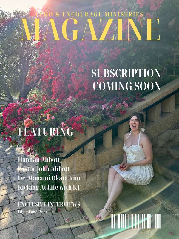 Woman in white dress sits on stone steps surrounded by vibrant flowers for magazine cover.
