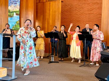 Group of singers performing in a church setting.