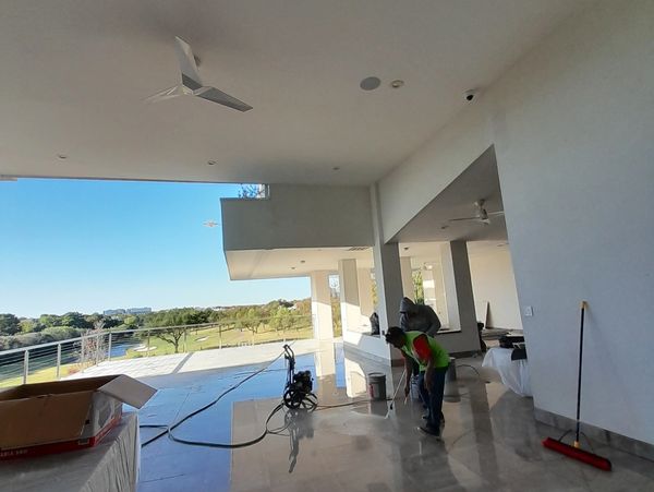 renovation and repair of ceiling stucco plaster on the exterior house protective plastic sheets.