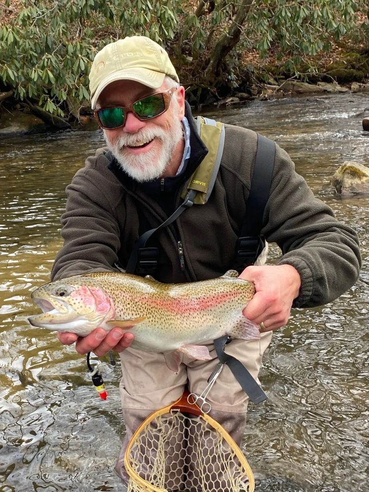 Fishing Guide holding a Trout