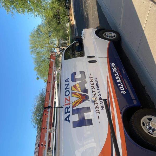 Arizona HVAC Department heating and cooling service van parked on a sunny street.