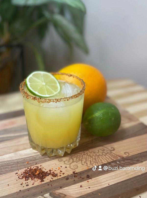 Mocktail margarita with a spicy simple syrup and Tajin rim. 
