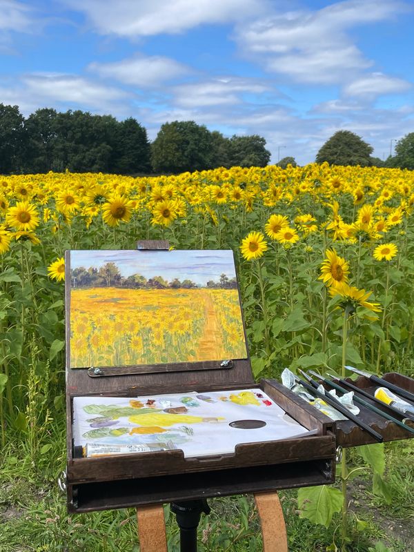 Oil painting in sunflower field.