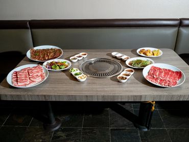 Korean BBQ dipping sauces and condiments in white ceramic dishes