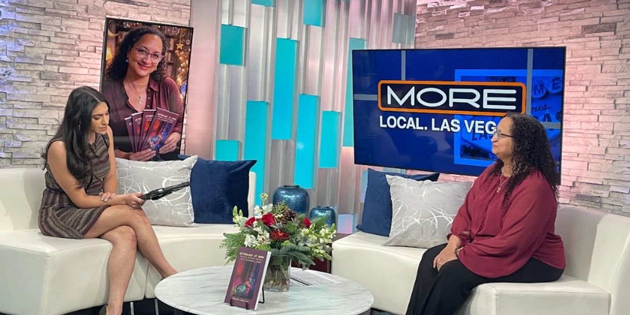 Two women in a TV studio discussing a book, with the show title 'MORE Local Las Vegas' on screen.