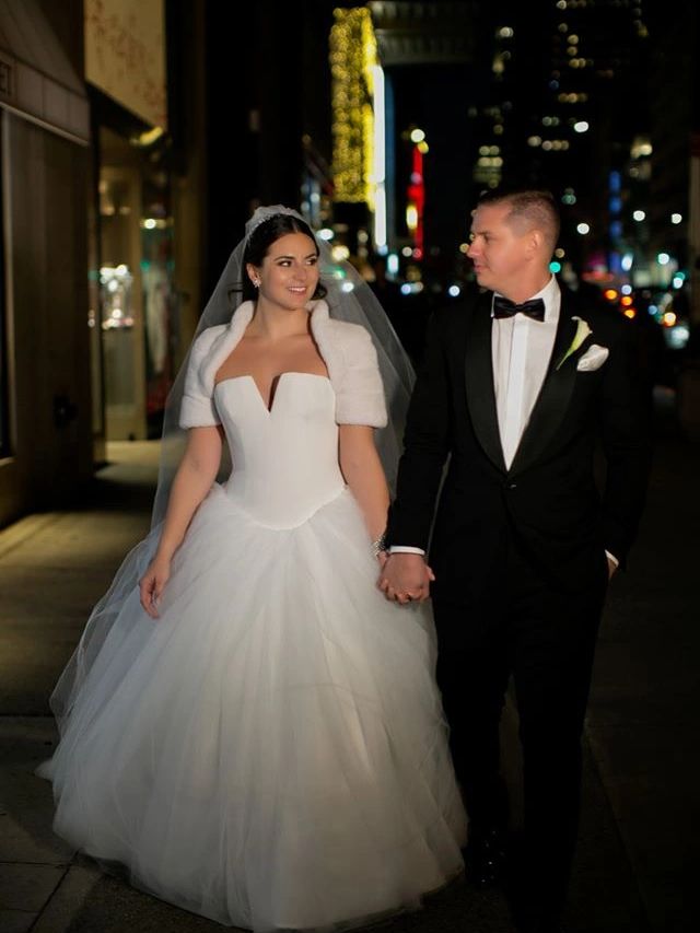 Bride and groom holding hands at night.