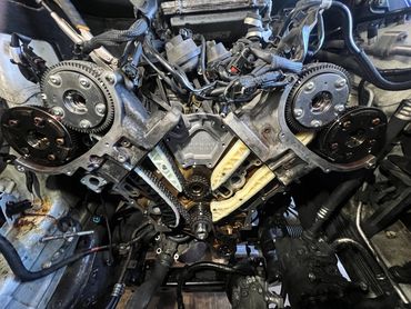 Close-up of a Mercedes-Benz engine timing chain and camshaft gears.