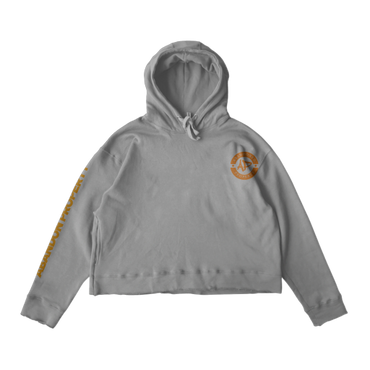 Gray cropped hoodie with orange logo and text on sleeve.