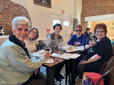 A group of friends sitting and having glass of wine 