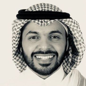 Portrait of a smiling man wearing traditional Middle Eastern attire.