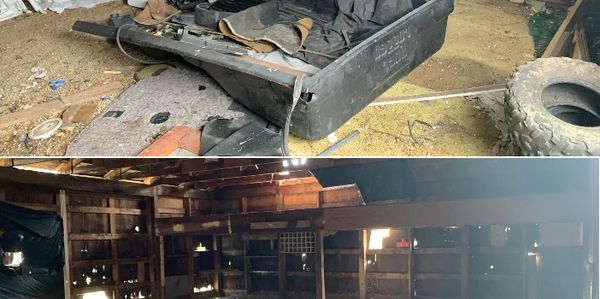 Old, dusty workshop with tools and tires scattered around.