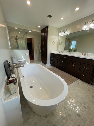 custom master bathroom with large vanity and stand alone tub