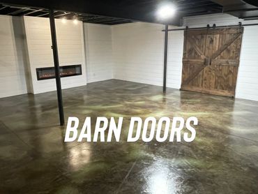 studio conversion stained concrete floor with shiplap walls