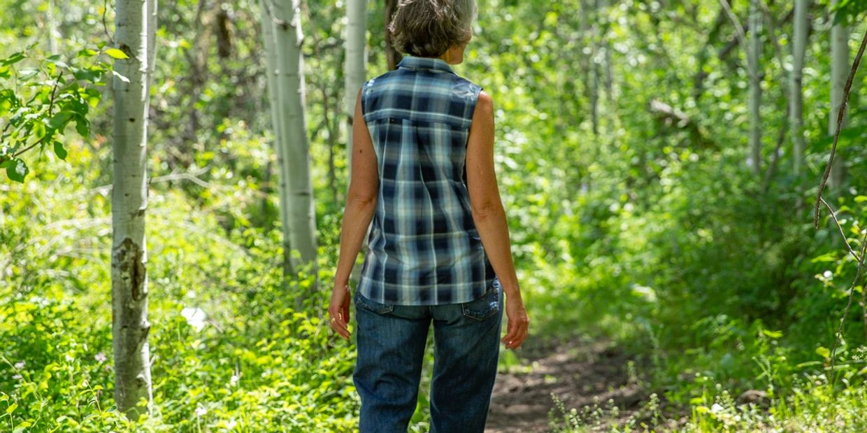 Amy Layne Litelman walking in the forrest.