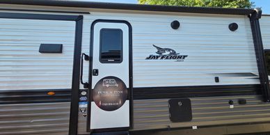 Exterior side view of a Jay Flight RV door.
