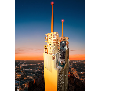 Sunset view of a tall building with antennas and intricate rooftop structures.