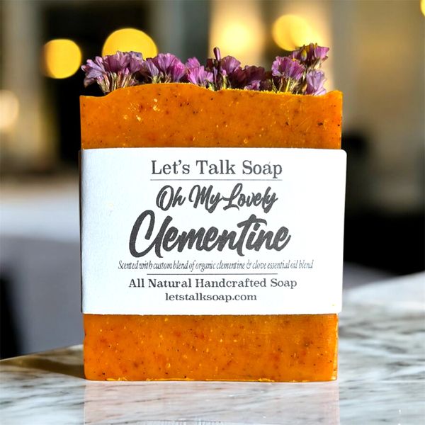 JOLLY CITRUS WARM SCENTED SOAP. ORANGE COLOR. DISPLAYING ON TABLE.