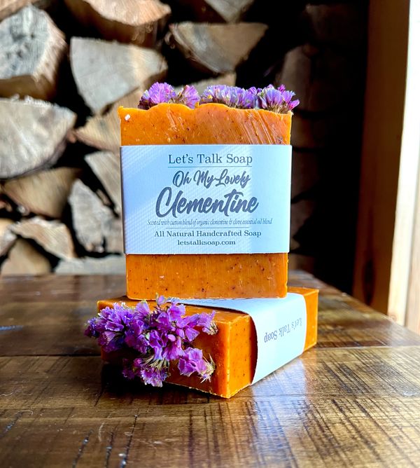 JOLLY CITRUS WARM SCENTED SOAP. ORANGE COLOR. DISPLAYING ON TABLE.