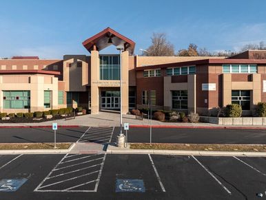 Modern educational building with accessible parking in front.