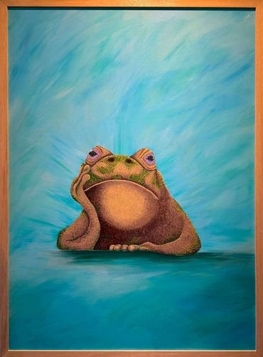 A contemplative frog resting its head on its hand against a blue backdrop.