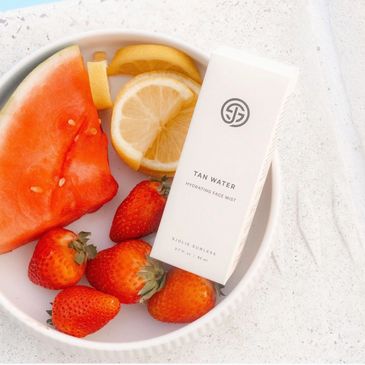 Skincare product with fresh fruit on a plate.