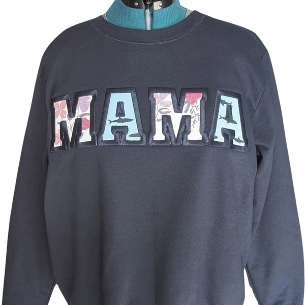 Navy Blue Sweater with the Word MAMA Appliqued onto it utilizing a baby onesie.