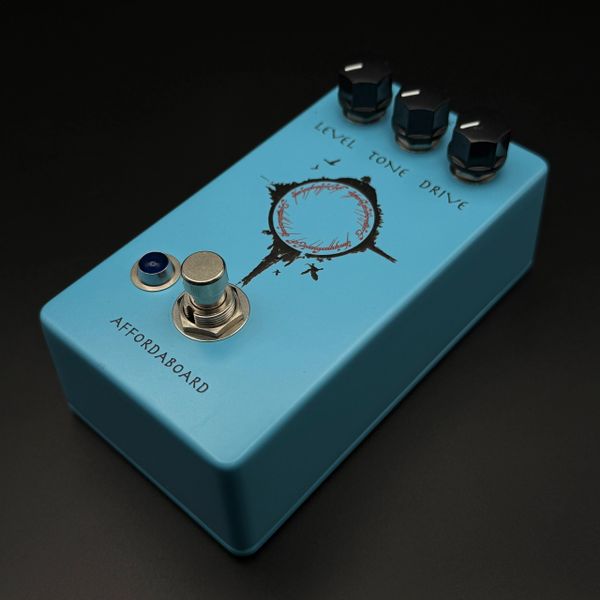 Blue guitar effects pedal with three knobs and a footswitch.