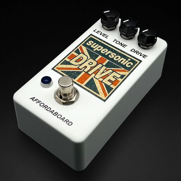 White guitar effects pedal labeled Supersonic Drive with three control knobs and a footswitch.