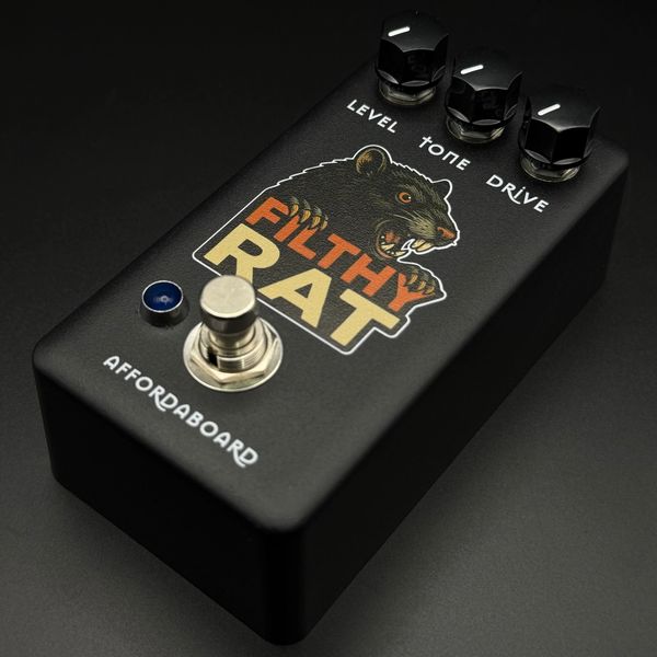 Black guitar pedal with a fierce rat graphic labeled 'Filthy Rat' and control knobs for level, tone, and drive.