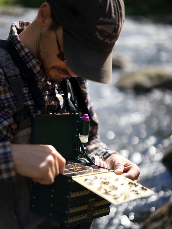 Fly fishing guide John Ruff selecting the appropriate fly in the Adirondacks