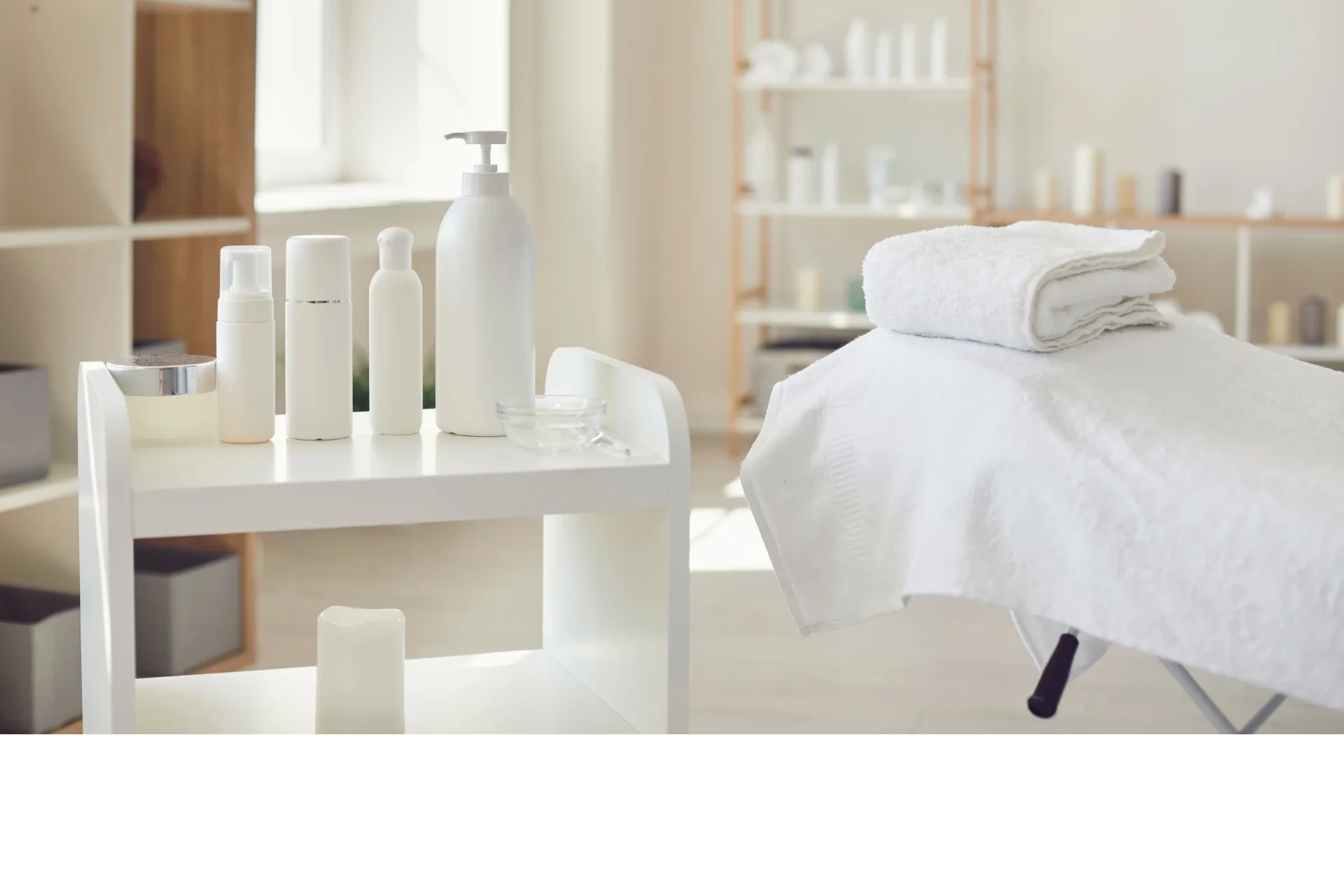 Image of spa room that contains servicing bed and high-quality skincare products.