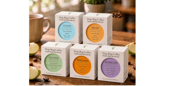 Five boxes of drip bag coffee on a wooden table.