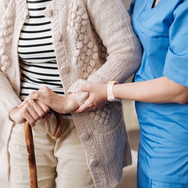 Gentle trained nurse helping mature patient