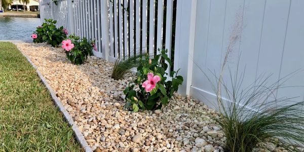 Beautiful hibiscus and native Florida muhly grass floral stone garden bed.