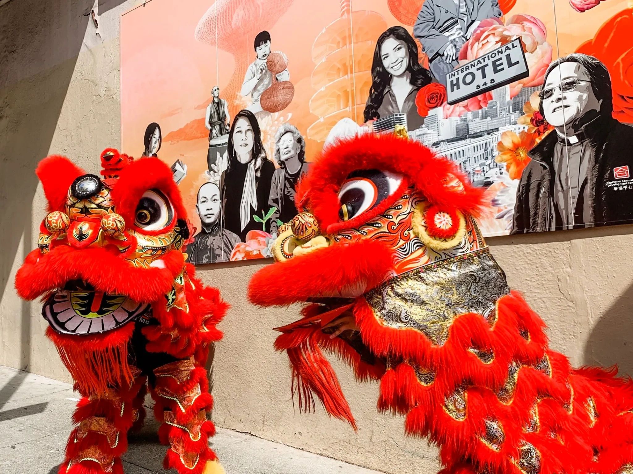Chinese lions in front of AAPI Community Heroes Mural in San Francisco Chinatown