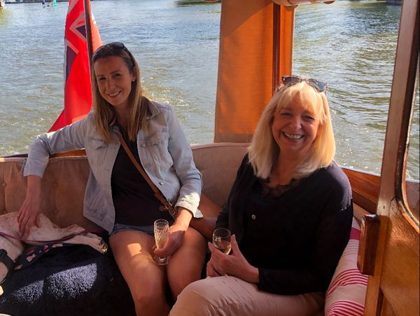 happy women on the boat drinking champagne