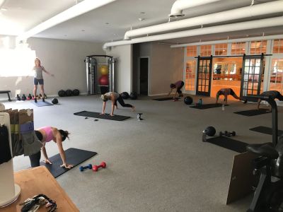 People exercising in a gym room.