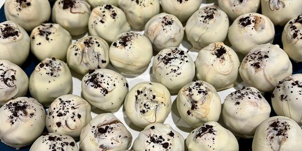 White chocolate espresso truffles. White choc covered ganache balls sprinkled with ground coffee.