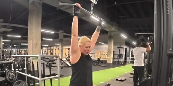 I am standing confidently in a gym in training gear about to start my workout