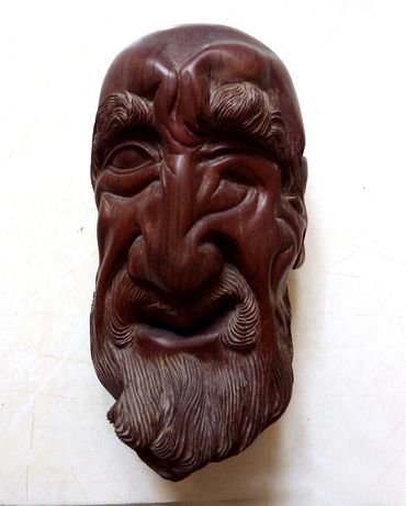 Sculptor Tomas Oliva, a head of an old man, wood carving in Caguiran, 1974