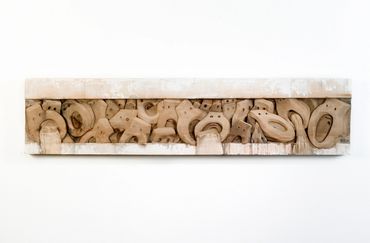 Entrenched Prisoners (Prisioneros atrincherados) 2005, bas-relief in wood, 17" x 72" x 3"
