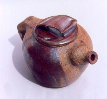 This teapot features a delicate drip of classic cone 10 reduction iron glaze, Olympic College
