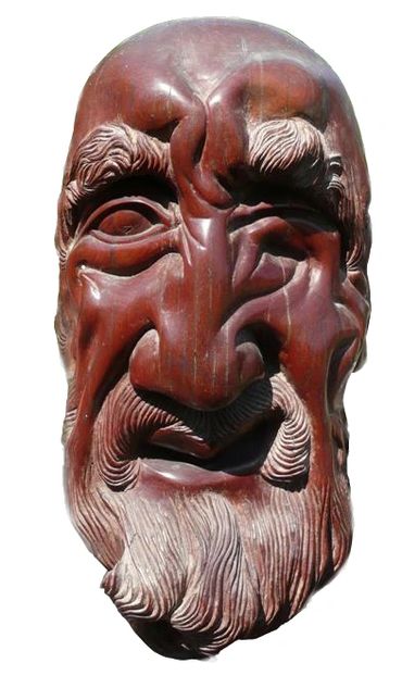 Sculptor Tomas Oliva, a head of an old man, wood carving in Caguiran, 1974