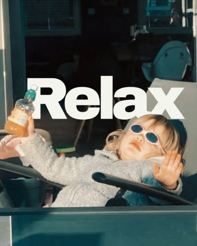Child relaxing with sunglasses and a drink.
