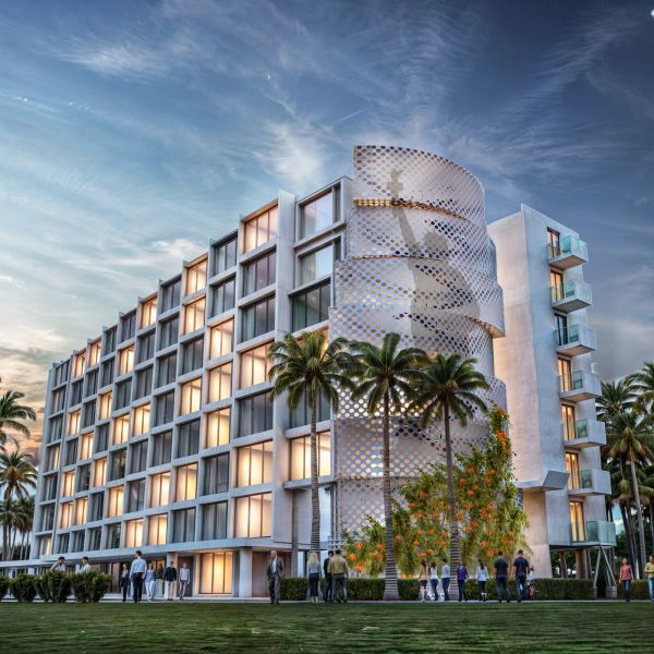 Modern hotel building with palm trees under a cloudy sky.