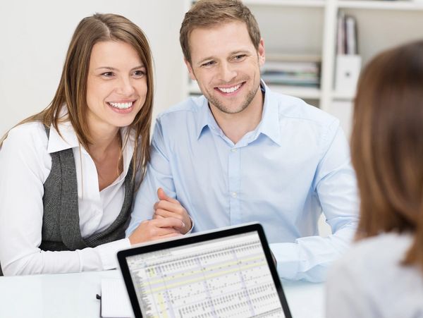 Attractive young couple in a meeting with their business and investment advisor 