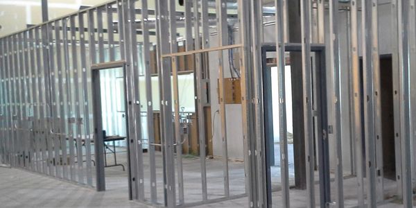 Metal wall framing inside an unfinished building under construction.