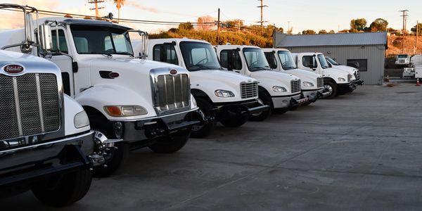 Row of water trucks included in Collinsworth Construction fleet of Rental Equipment