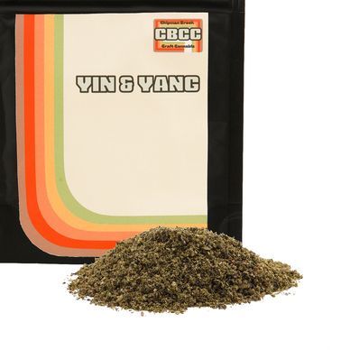 Packet of CBCC Yin &amp; Yang craft cannabis with loose cannabis in front.
