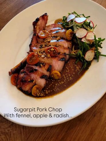 Grilled sugarpit pork chop with mustard seeds and fresh radish salad.
